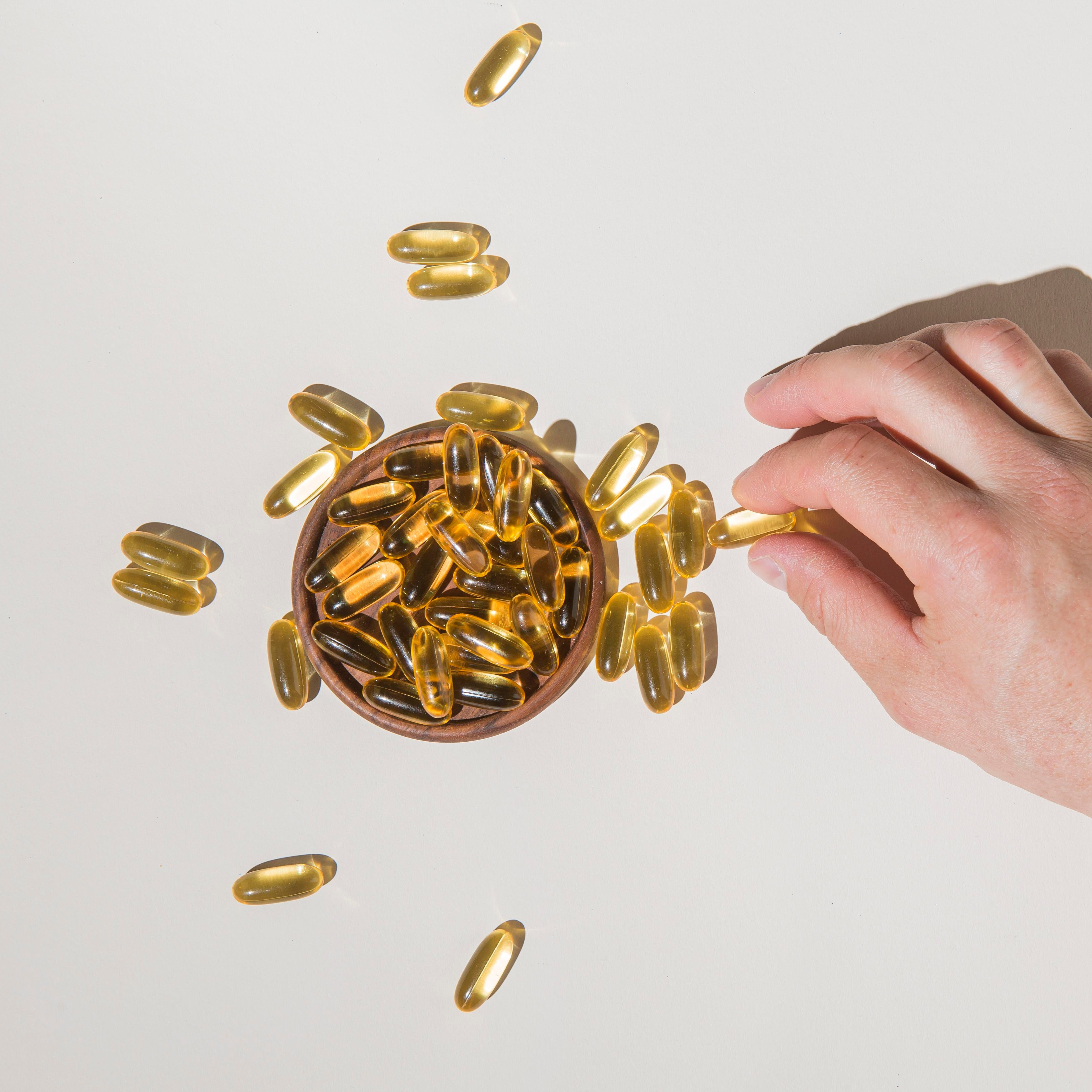 top-view-hand-picking-medical-capsules.png